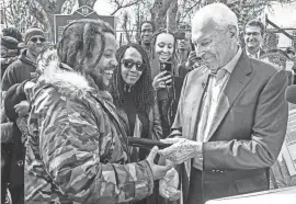  ?? PHOTOS BY BENJAMIN CHAMBERS/DELAWARE NEWS JOURNAL ?? Stephen Marley, son of Bob and Rita Marley, accepts the key to the city from Mayor Purzycki at One Love Park/Tatnall Street Park in Wilmington on Wednesday. Stephen Marley was born in Wilmington and lived at the family's home on 24th Street.