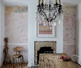  ??  ?? ABOVE LEFT & ABOVE Marta has scraped back layers of paint and wallpaper to reveal original, soft pink plaster walls. The time-worn medieval dining table was given to Marta’s father by a client, and the glamorous chandelier once graced the Bloomsbury offices of The Spectator magazine OPPOSITE The Antelope chairs are originals from Ernest Race and were designed in 1951 for the Festival of Britain BELOW The original paint and weathered patina of the red and green basement staircase was left as it was by Marta to reflect the passing of time