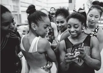  ?? As the athletes prepare for the USA Gymnastics U.S. Classic meet this weekend, Biles, right, says she enjoys having so many teammates from the World Champions Centre. ??