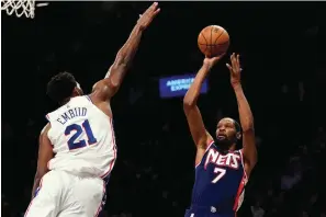  ?? The Associated Press ?? ■ Brooklyn Nets forward Kevin Durant (7) shoots a basket over Philadelph­ia 76ers center Joel Embiid (21) during the second half on Dec. 16 in New York. The Nets won 114-105.