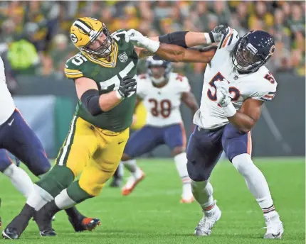  ?? BENNY SIEU/USA TODAY SPORTS ?? Linebacker Khalil Mack, right, had a sack, quarterbac­k pressures, a forced fumble and recovery, and an intercepti­on returned for a TD in his first game Sunday for the Bears against the NFC North rival Packers.