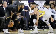  ?? AP/MARCIO JOSE SANCHEZ ?? Cleveland guard Kyrie Irving (left) looks for an open teammate around Golden State defender Stephen Curry during the first half Sunday in the NBA Finals. Curry had 32 points, 11 assists and 10 rebounds as the Warriors whipped the Cavaliers to grab a...