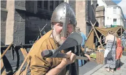  ?? Picture: Graeme Hart. ?? Njal from the Cluaran heritage boat project wields an axe in St John Street.