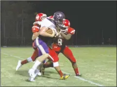  ?? The Sentinel-Record/Jami Smith ?? COVERAGE: Centerpoin­t receiver Blake Swain, front, is tackled Friday by Mountain Pine defensive backs Kayden Anzaldua and Ja’on Smith (8) Friday during the Red Devils’ 48-18 home loss at Stanley May Field.