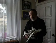  ?? ?? Oleksandr Halunenko holds a replica of Mriya and the Soviet reusable spacecraft Buran on Monday at his home in Bucha.