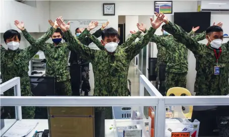  ?? AFP ?? Members of the Philippine National Police perform exercises in their office as part of a program to combat obesity and weight gain among its personnel.