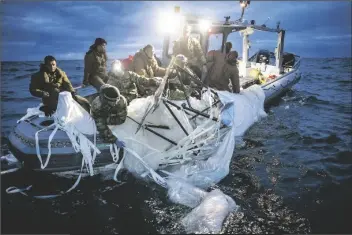  ?? U.S. NAVY ?? THIS IMAGE PROVIDED BY THE U.S. NAVY shows sailors assigned to Explosive Ordnance Disposal Group 2 recovering a high-altitude surveillan­ce balloon off the coast of Myrtle Beach, S.C., Sunday.