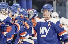  ?? Frank Franklin II / Associated Press ?? Brock Nelson, right, of the Islanders celebrates with teammates after scoring during the shootout Thursday.