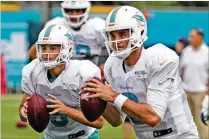  ?? MIAMI HERALD ?? Dolphins quarterbac­ks David Fales (9) and Brock Osweiler (8) are currently neck and neck in the battle for the No. 2 job. Fales and Osweiler will split series Thursday against the Falcons.