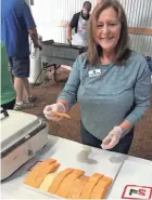  ?? KEITH UHLIG/USA TODAY NETWORK-WISCONSIN ?? Sen. Kathy Bernier (R-Lake Hallie) handed out slices of cheese, including Colby cheese, at the Colby June Dairy Month Breakfast recently.