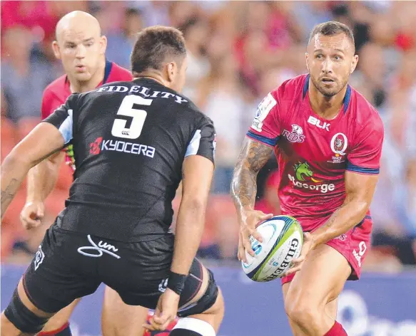  ?? Picture: GETTY IMAGES ?? Queensland Reds playmaker Quade Cooper looks for support against the Sharks at Suncorp Stadium on Friday night.