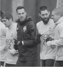  ?? — AP ?? TUKWILA: Seattle Sounders including forward Clint Dempsey, center, and team captain midfielder Osvaldo Alonso, second from right, jog during the first training session of the 2017 MLS soccer season, Tuesday, in Tukwila, Wash.