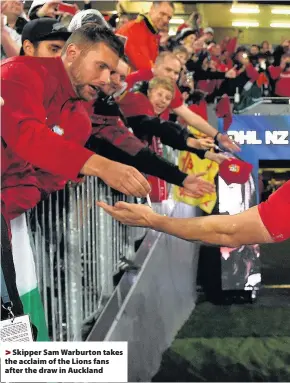  ??  ?? > Skipper Sam Warburton takes the acclaim of the Lions fans after the draw in Auckland