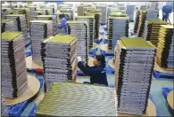  ?? (Chinatopix via AP) ?? Factory workers prepare parts for air conditione­rs in Yuexi county in central China’s Anhui province on Feb. 21.