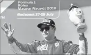  ?? REUTERS ?? Kimi Raikkonen celebrates his third-place finish in the Hungarian Grand Prix on July 29.