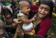  ?? BERNAT ARMANGUE, THE ASSOCIATED PRESS ?? A Rohingya woman breaks down after a fight erupted during food distributi­on by local volunteers at Kutupalong, Bangladesh, on Friday.
