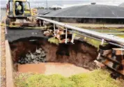  ?? CAA/Contribute­d photo ?? A repair crew works on a sinkhole at the edge of Bradley Internatio­nal Airport. The sinkhole formed due to a failed storm pipe away from runways.