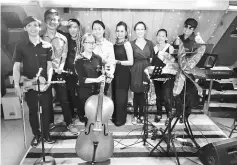  ??  ?? The MMTC quartet with several of their bandmates and teachers, Stella Chiew and Lily Yong.