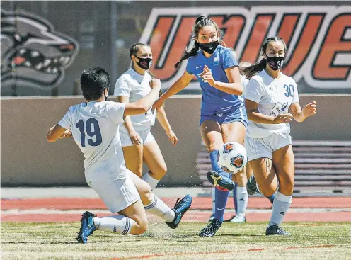  ?? PHOTOS BY GABRIELA CAMPOS/THE NEW MEXICAN ?? St. Michael’s Rachael Morgan kicks to a teammate during Thursday’s championsh­ip game against Socorro in Albuquerqu­e. The Lady Horsemen won 4-1.