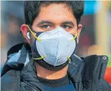  ?? KENA BETANCUR AFP VIA GETTY IMAGES ?? A study found that one mask blocks 40 per cent of virus particles, while two masks block 80 per cent.