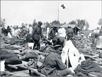  ??  ?? Russian soldiers seen here suffering the effects of poison gas being cared for by members of the Russian Red Cross not far from the front line trenches. Circa August 1915.Photo Daily Mirror