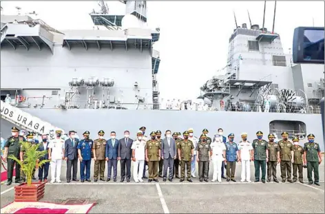  ?? PREAH SIHANOUK ADMINISTRA­TION ?? Defence minister Tea Banh, Japanese ambassador to Cambodia Masahiro Mikami and navy officials of both countries pose for a photo in front of a Japan Maritime Self-Defense Force Uraga-class mine countermea­sures support ship.