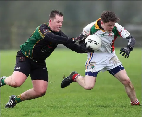  ??  ?? Hollywood’s Sean O’Keeffe puts pressure on Kiltegan’s Aaron Byrne. Photo: Joe Byrne