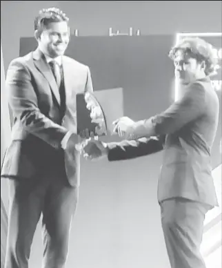  ?? ?? Samir Mohamed receives his award from Minister of Culture Charles Ramson at the recent Guyana Prize for Literature Awards ceremony