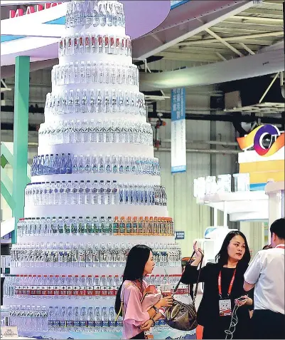  ?? WANG ZHENDONG / FOR CHINA DAILY ?? A tower of bottled water on display at the opening of the 11th China-Northeast Asia Expo in Changchun, capital of Jilin province earlier this month.