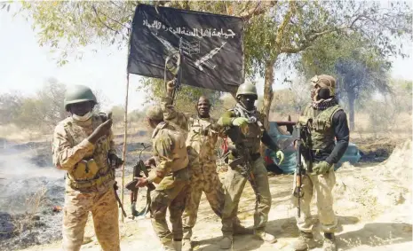  ?? (FILE PHOTO) ?? Soldiers under Operation LAFIYA DOLE dismantle Boko Haram terrorists’ flag at Parisu, Camp Zero in Sambisa forest, Borno State, signifying the capture of the terrorists’ Headquarte­rs