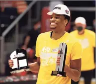  ?? Jay LaPrete / Associated Press ?? St. Bonaventur­e’s Osun Osunniyi, a Putnam Science Academy graduate, shows off his All-Tournament team and Most Outstandin­g Player awards after the Bonnies’ win over VCU in the Atlantic-10 championsh­ip Sunday.