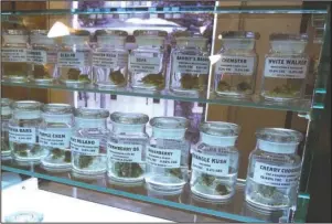  ?? The Associated Press ?? SUNDAY, SUNDAY, SUNDAY: This Tuesday photo shows marijuana on display at Arbors Wellness in the medical marijuana shop in Ann Arbor, Mich. Adults age 21 and over will be able to buy marijuana for recreation­al use starting Sunday in Michigan.