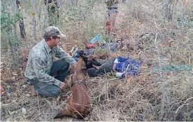  ?? Picture: Supplied ?? MISSION ACCOMPLISH­ED. The Endangered Wildlife Trust’s antipoachi­ng dog Annie with her handler, Colin, and the two poaching suspects arrested in the Kruger National Park recently.