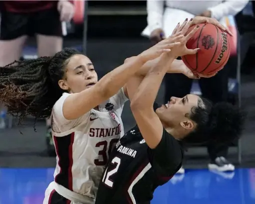  ?? Associated Press ?? Stanford’s Haley Jones blocks a shot by South Carolina’s Brea Beal in the second half of the Cardinal’s 66-65 win Friday. Jones led Stanford with 24 points, shooting 11 of 14 from the field.