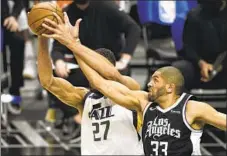  ?? Kelvin Kuo Associated Press ?? NICOLAS BATUM, right, back in the starting lineup after missing two games, battles Utah center Rudy Gobert for a rebound.