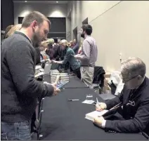  ?? Arkansas Democrat-Gazette/FRANCISCA JONES ?? Ben Coulter (left) of Wheatley has author Eric Metaxas sign a copy of Martin Luther at a reception held after “City Center Conversati­ons: Conversati­ons About God, Life and Faith in the City” at the Robinson Center Performanc­e Hall.