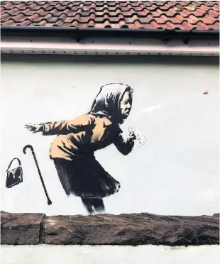  ??  ?? Banksy’s latest mural which appeared on a wall in Bristol – See Question 2