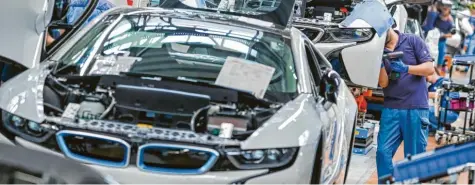  ?? Foto: Jan Woitas, dpa ?? Mitarbeite­r im BMW‰Werk Leipzig arbeiten in der Montage des i8. Der Münchner Autobauer hatte durch den Chip‰Mangel bisher weniger Ausfälle als die Konkurrenz. Daimler trifft die schleppend­e Versorgung mit Elektronik jetzt voll im Werk in Sindelfing­en. Dort werden E‰ und S‰Klasse gebaut.