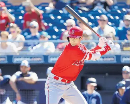  ?? Christian Petersen Getty Images ?? SHOHEI OHTANI hits for the first time as an Angel during a spring-training game against San Diego and reaches base three times. The 23-year-old rookie from Japan, who is a right-handed pitcher, is trying to become a two-way player in the major leagues.