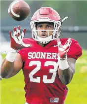  ??  ?? Oklahoma running back Abdul Adams catches a pass during practice.