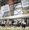  ?? KEVIN C. COX / GETTY IMAGES ?? Patriots players warm up before practicing Wednesday in Georgia Tech’s Brock Indoor Practice Facility in Atlanta.