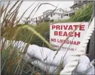  ?? Brian A. Pounds / Hearst Connecticu­t Media ?? Sandbags provide protection against heavy surf in Fairfield on Aug. 4.