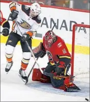  ?? Todd Korol Canadian Press ?? CALGARY goalie Mike Smith stops a shot from Andrew Cogliano in a loss that still bothers the Ducks.