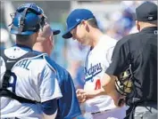  ?? Wally Skalij Los Angeles Times ?? DODGERS STARTER Rich Hill, center, leaves the game because of a blister on his left middle finger.