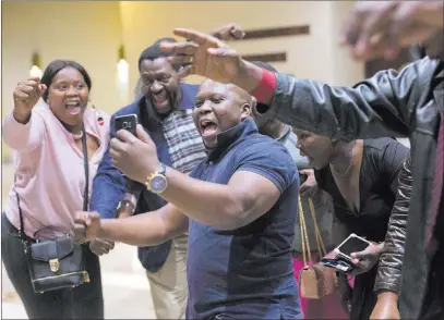  ?? Jerome Delay ?? The Associated Press ZANU-PF supporters celebrate the victory of their candidate Emmerson Mnangagwa after Zimbabwe Electoral Commission chairwoman Qhubani Moyo announced the results of the presidenti­al elections Friday in Harare, Zimbabwe.