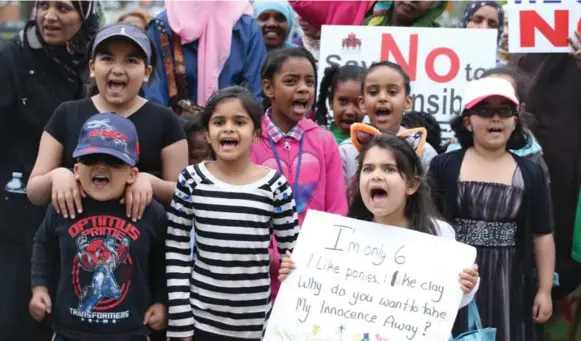  ?? VINCE TALOTTA/TORONTO STAR ?? About a thousand parents and children showed up at Queen’s Park Monday to protest Ontario’s new sex-ed curriculum. Across the city, almost 35,000 kids were absent from school.