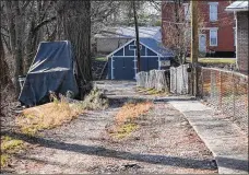  ??  ?? Erica Riddick now uses this unlit easement from Chambers Street to get to her Vandalia Avenue home in Northside.