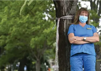  ?? Helen H. Richardson, The Denver Post ?? Gwen Nienhueser, a registered nurse at Fairacres Manor, remembers the victories among the loses to COVID-19. “The first one that I remember (having COVID-19) is still with us,” Nienhueser said, recalling a woman in the long-term care unit. “She survived — she’s 90-some years old, too — and she’s a strong little lady.”