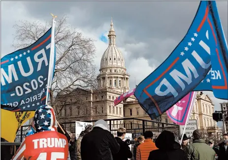  ?? EMILY ELCONIN/THE NEW YORK TIMES ?? Supporters of President Trump protest election results Tuesday at the Michigan Capitol in Lansing.