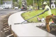  ?? Brian A. Pounds / Hearst Connecticu­t Media ?? Workers from Edo Constructi­on install a cement sidewalk on North Street in Milford on Tuesday.